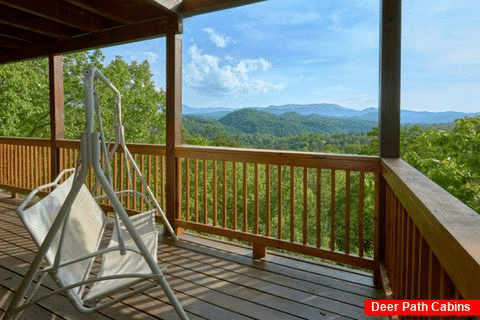 Cabin with porch swing overlooking mountain view - A Lazy Bear's Hideaway