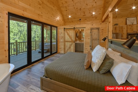 King bedroom with private deck in rental cabin - Tennessee Treehouse
