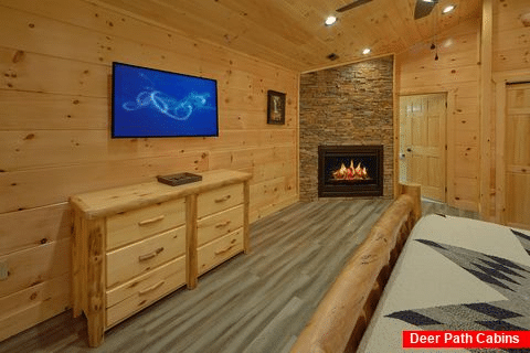 Cabin master bedroom with fireplace and king bed - Splashing Bear Cove