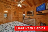 King bedroom with TV and fireplace in cabin 