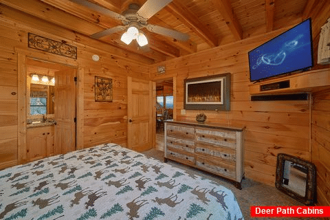 King bedroom with TV and fireplace in cabin - Chocolate Moose