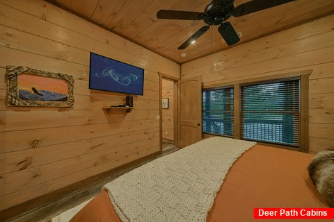 Master bedroom with TV and bath in resort cabin - A View From Above