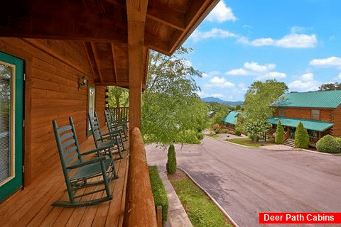 Cabin with rocking chairs and resort pool - Timber Lodge